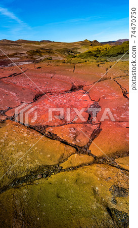 Amazing Icelandic landscape of colorful volcanic caldera Askja, in the middle of volcanic desert in Highlands, with red and turquoise volcano soil and hiking trail, Iceland, at summer and blue sky 74470750