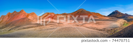 Panoramic view over volcanically active zone in Highlands of Iceland, resembling Martian red planet landscape, with black volcano and red slopes, at summer and blue sky. 74470751