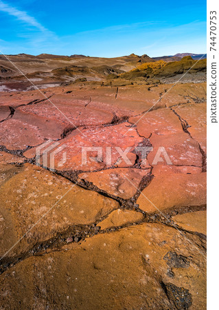 Amazing Icelandic landscape of colorful volcanic caldera Askja, in the middle of volcanic desert in Highlands, with red and turquoise volcano soil and hiking trail, Iceland, at summer and blue sky Amazing Icelandic landscape of colorful volcanic caldera Askja, in the middle of volcanic desert in Highlands, with red and turquoise volcano soil and hiking trail, Iceland, at summer and blue sky 74470753