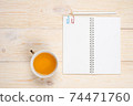 empty notebook with tea cup on white wooden table 74471760