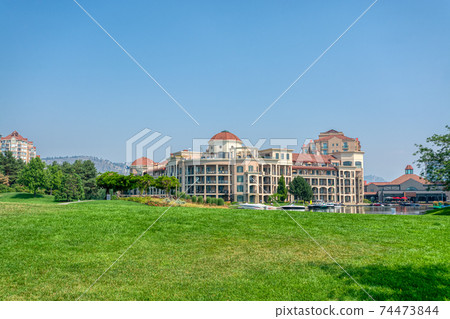 Landscape with luxury residential buildings and boat pier at front Landscape with luxury residential buildings and boat pier at front 74473844