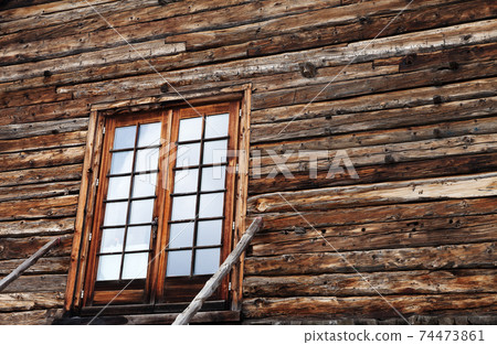 Wooden house with glazed front door and staircase with railing Wooden house with glazed front door and staircase with railing 74473861