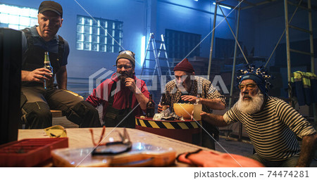 Adult man winning money from friends while watching match 74474281