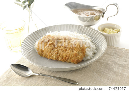 Curry pot with hot rice with pork cutlet and roux, natural cheese topping, tea and olive leaves Curry pot with hot rice with pork cutlet and roux, natural cheese topping, tea and olive leaves 74475957