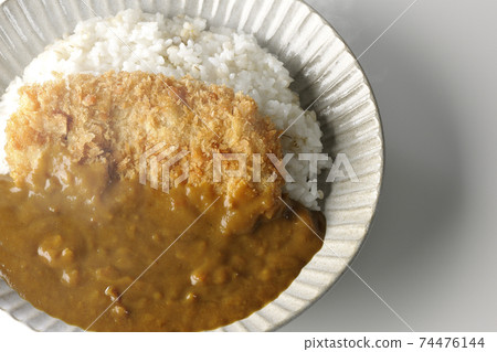 A hot cutlet curry with a large pork cutlet in the middle taken on a white background (overhead view) 74476144
