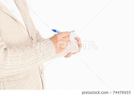 A man writing notes in a notebook 74476935