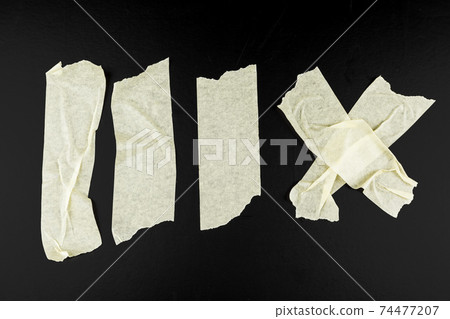 Set of various adhesive tape pieces on black background Set of various adhesive tape pieces on black background 74477207