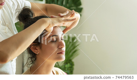 Face massage treatment in the spa salon, Girl receiving holistic massage treatment. Face massage treatment in the spa salon, Girl receiving holistic massage treatment. 74479563