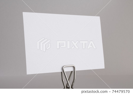 Clip with a white paper card Clip with a white paper card 74479570