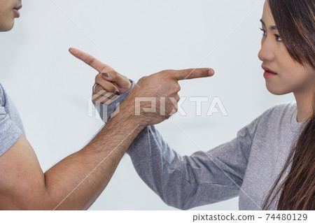 couple pointing fingers at each other blame argument togetherness while quarrel in the room. couple pointing fingers at each other blame argument togetherness while quarrel in the room. 74480129