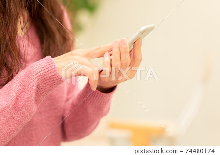 middle woman using smartphone middle woman using smartphone 74480174