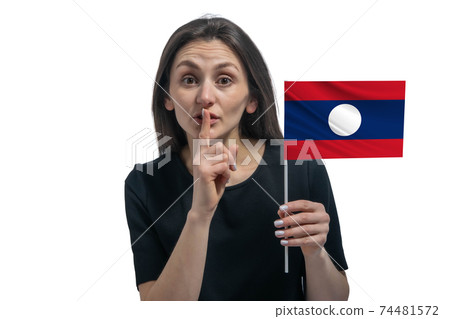 Happy young white woman holding flag of Laos and holds a finger to her lips isolated on a white background 74481572