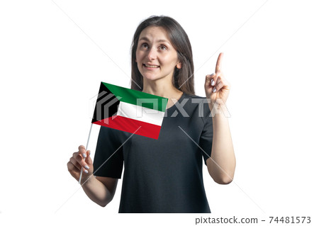 Happy young white woman holding flag of Kuwait and points thumbs up isolated on a white background Happy young white woman holding flag of Kuwait and points thumbs up isolated on a white background 74481573