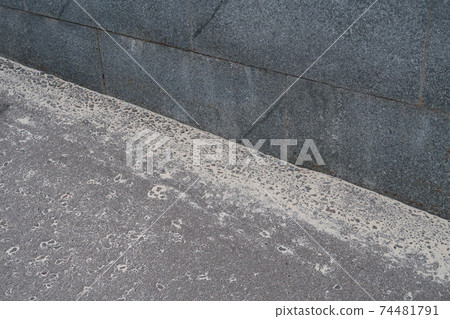 Granite curb and sand on dark asphalt Granite curb and sand on dark asphalt 74481791