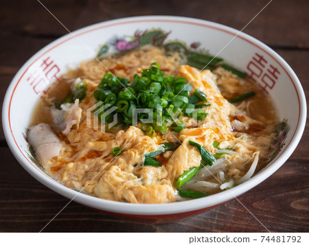 Hot and sour soup noodles topped with green onions and beaten eggs (Suratan Sanrattan). Hot and sour soup noodles topped with green onions and beaten eggs (Suratan Sanrattan). 74481792