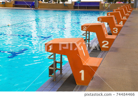 Jumping stand marked number one to eight in the lanes of swimming pool, water sport, swimming pool center. 74484466