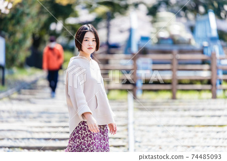 A woman watching cherry blossoms at Keage Incline during sightseeing in Kyoto 74485093