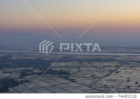 Evening view from Moriyama to Hachirogata in spring haze 74485118