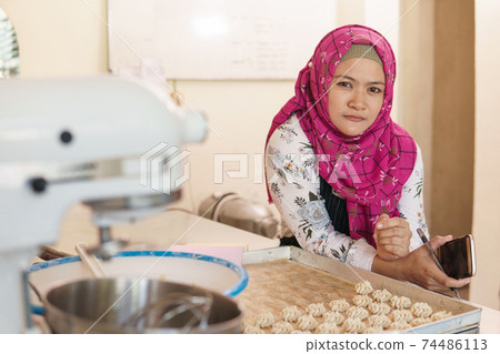 asian muslim baker looking at camera 74486113