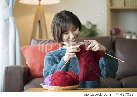 A young lady knitting A young lady knitting 74487838