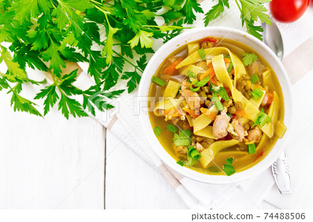 Soup with mung and noodles in bowl on light board top Soup with mung and noodles in bowl on light board top 74488506