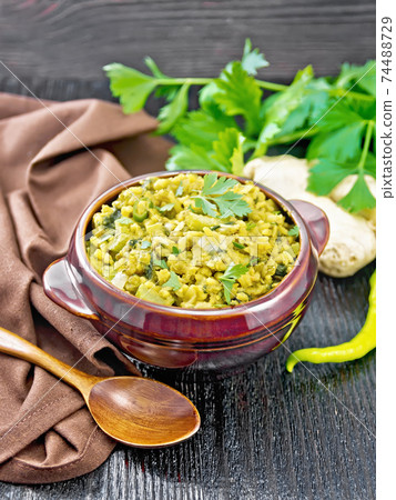 Kitchari in bowl on dark wooden board Kitchari in bowl on dark wooden board 74488729