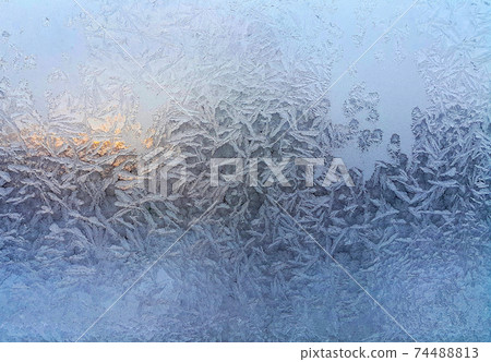Beautiful ice patterns on winter window 74488813