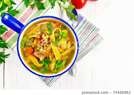 Soup with mung and noodles in blue bowl on board top Soup with mung and noodles in blue bowl on board top 74488962