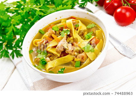 Soup with mung and noodles in bowl on light board 74488963