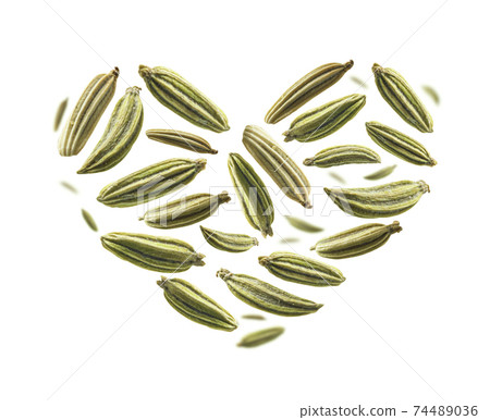 Fennel seeds in the shape of a heart on a white background Fennel seeds in the shape of a heart on a white background 74489036