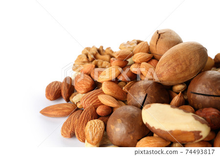 Heap of different tasty nuts isolated on white background Heap of different tasty nuts isolated on white background 74493817