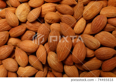 Tasty almond nuts on whole background, close up Tasty almond nuts on whole background, close up 74493818