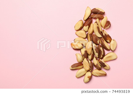 Tasty brazil nuts on pink background, space for text Tasty brazil nuts on pink background, space for text 74493819