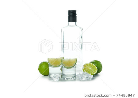 Bottle and shots of vodka, lime and ice isolated on white background Bottle and shots of vodka, lime and ice isolated on white background 74493947