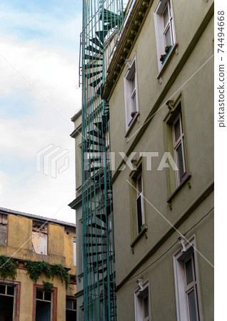 Close up of spiral fire escape on the facade of an old building in Istanbul 74494668