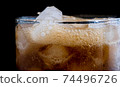 ice cube in fizzy splashing water with soda bubble 74496726