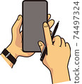 Hands of a man who operates a smartphone while holding a pen 74497324