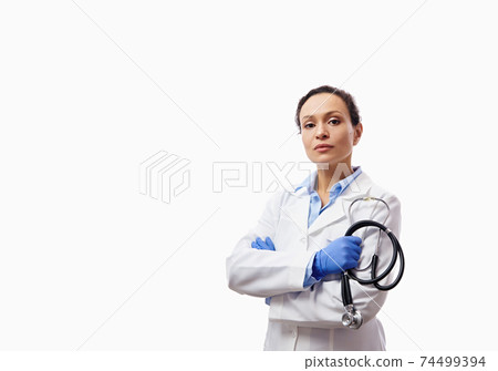 Confident portrait of a female doctor with crossed arms holding stethoscope isolated on white background with copy space. 74499394