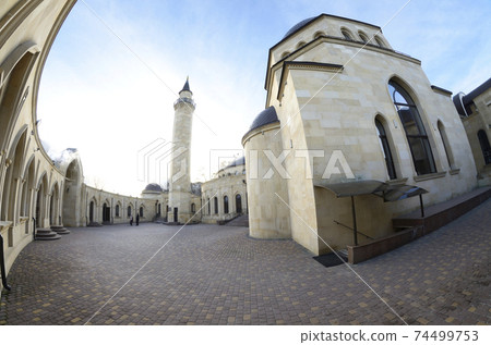 View of courtyard of the Ar-Rahma Mosque (Mercy Mosque) with building of the mosque itself, minaret, and domes 74499753
