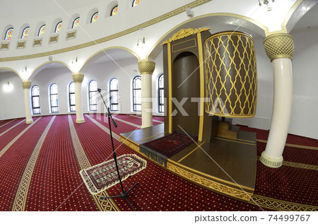 View of hall for praying (iwan) of the Ar-Rahma Mosque (Mercy Mosque) with minbar (pulpit). Kyiv, Ukraine 74499767