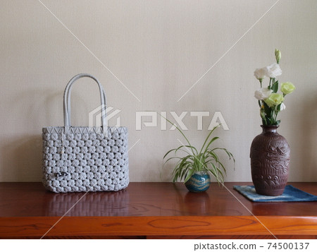 White handbag and vase with small accessories White handbag and vase with small accessories 74500137