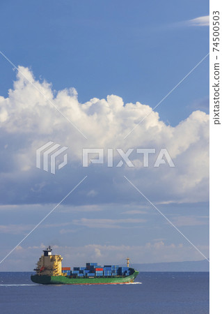 cargo ship nearby Capo Peloro Lighthouse in Punta del Faro on the Strait of Messina, most north eastern promontory of Sicily, Italy cargo ship nearby Capo Peloro Lighthouse in Punta del Faro on the Strait of Messina, most north eastern promontory of Sicily, Italy 74500503