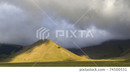 Dramatic mountain landscape near Castelluccio village in National Park Monte Sibillini, Umbria region, Italy 74500531