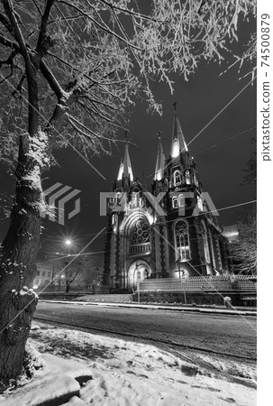 Grayscale. Beautiful illuminated night winter Church of Sts. Olha and Elizabeth in Lviv, Ukraine. Built in the years 1903-1911. 74500879