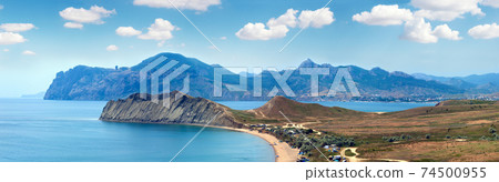Summer rocky coastline and camping on sandy beach (Tihaja Bay (Koktebel Town on right), Crimea, Ukraine ). All peoples and cars is aunrecognizable. 74500955