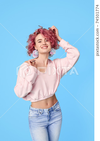 Young pink hair woman with carnation flower in earrings 74501774