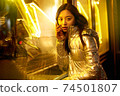 Trendy teenager girl posing in bright neon light 74501807