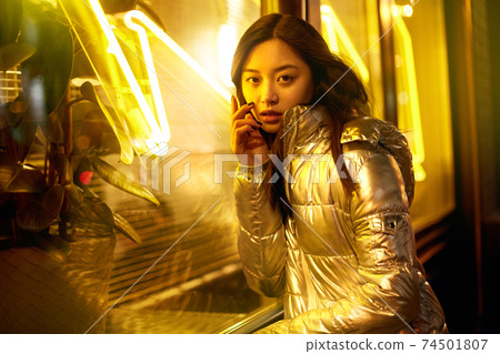 Trendy teenager girl posing in bright neon light Trendy teenager girl posing in bright neon light 74501807
