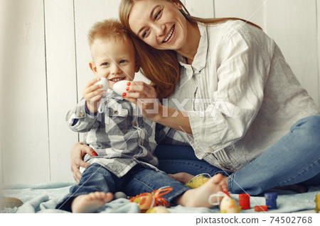 Mother with son at home prepare to easter 74502768