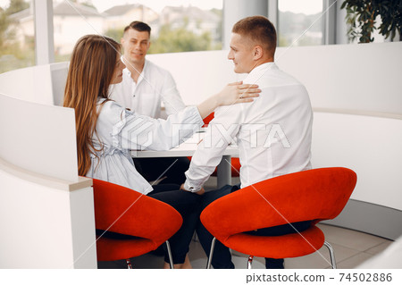 Stylish and elegant couple in a car salon 74502886